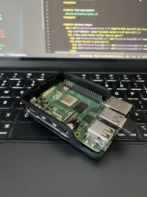 Raspberry Pi 4 in its case, resting on a laptop keyboard